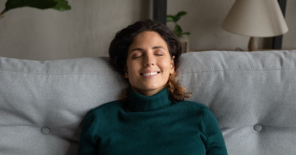 water leak detector - lady relaxing on the couch because she knows her water pipes are fine.