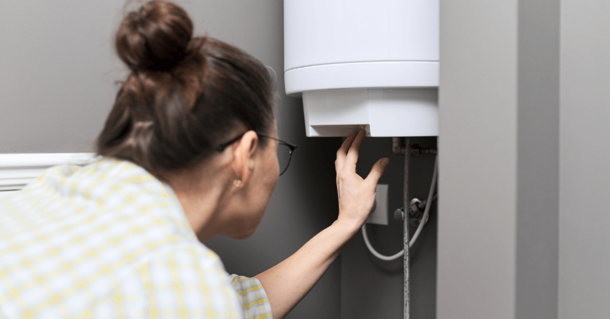 A person inspecting their gas geyser before repair 