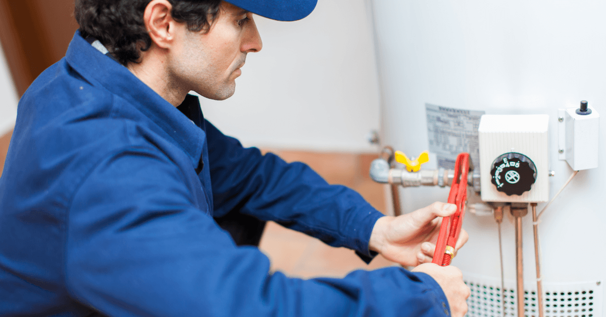 A plumber repairing a clients gas geyser 