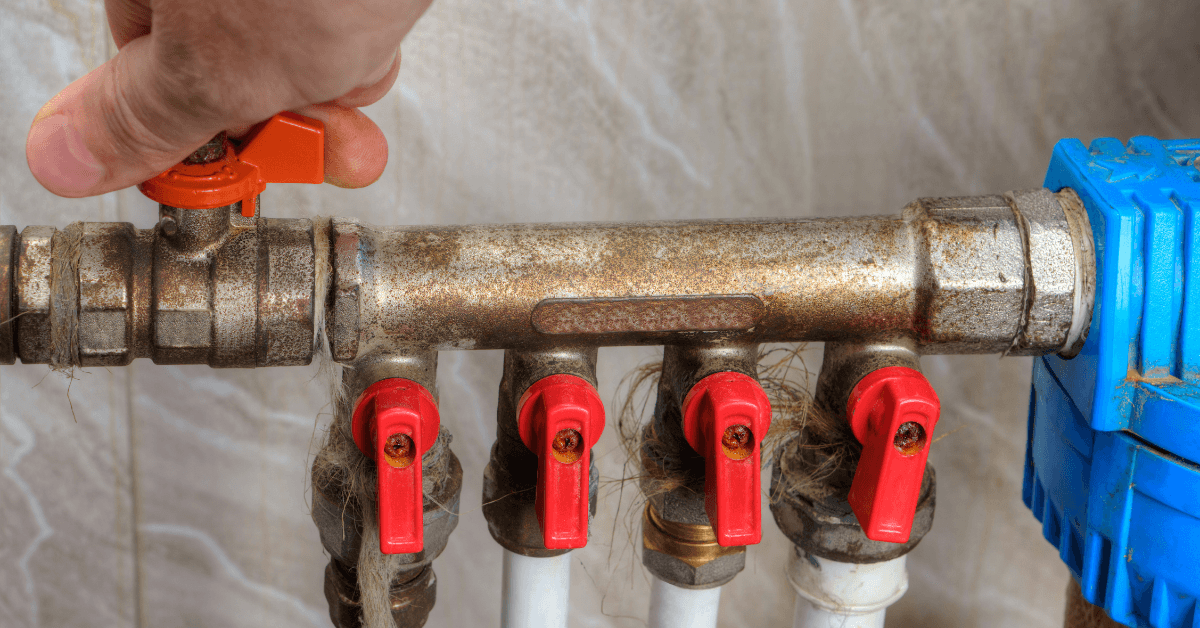 A person turning their water off