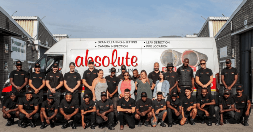 The Absolute plumbing team standing infront of their van