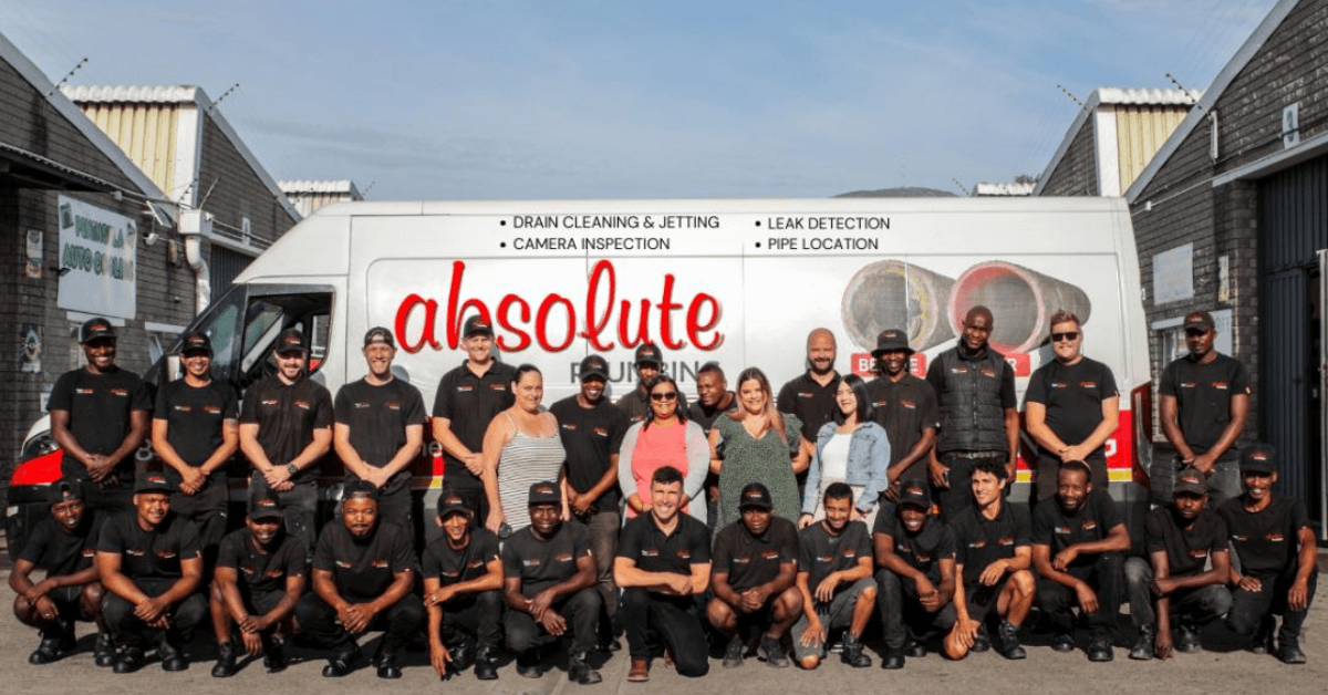 The Absolute plumbing team standing infront of their van