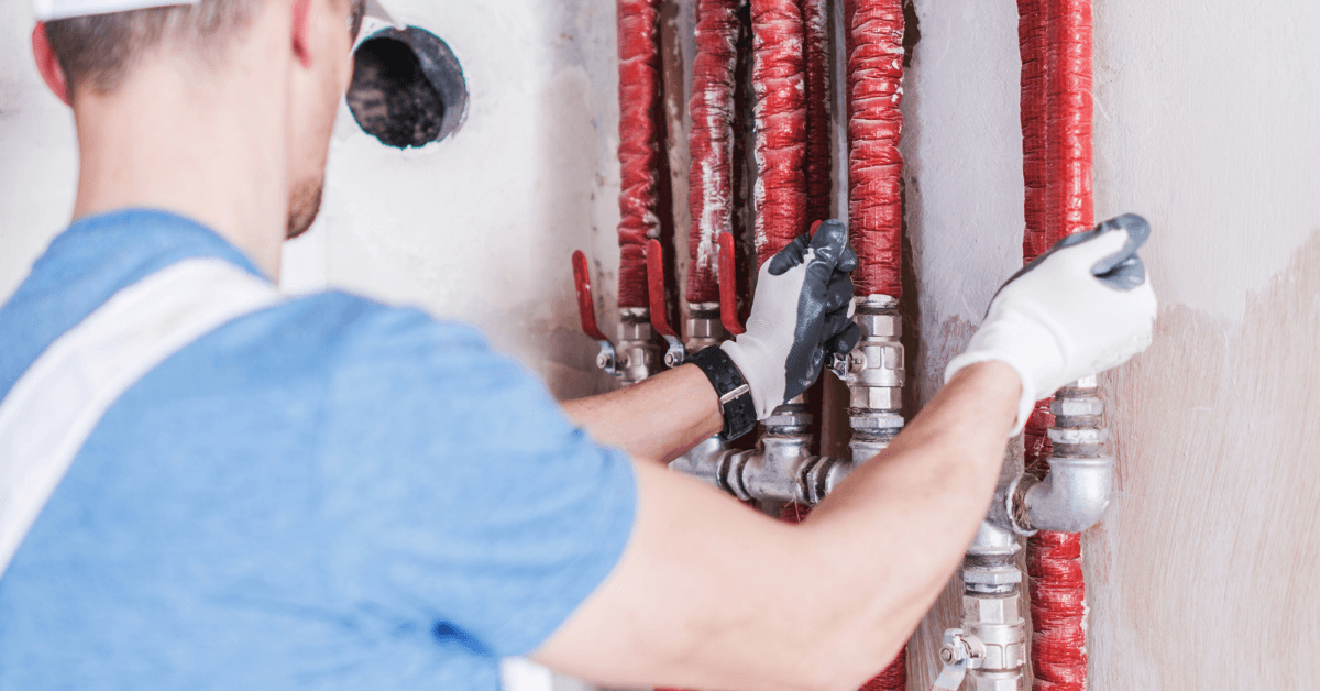 Plumber checking water pressure with water valves