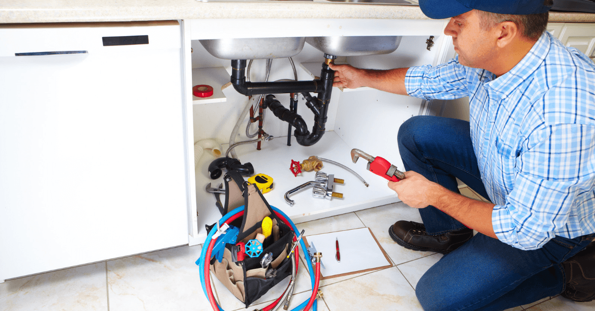 Plumber checking pipes for water flow restrictions